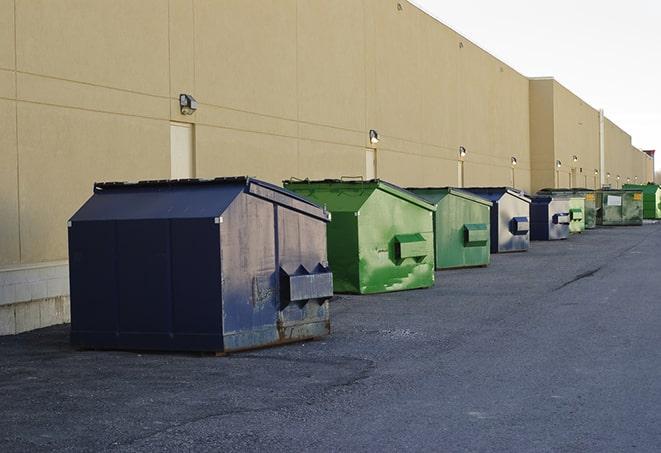 multiple construction dumpsters at a worksite holding various types of debris in Bulls Gap, TN